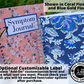 The large floral pink and smaller floral blue book are shown closed standing uup. A note says shown in coral flowers and blue gold floral. An arrow is pointing to the label on the pink journal and attached to a note that says Optional Customizable Label. Choose add-on customization level and write what text you want. Please check your email- you will be emailed font/color options after purchase. A circle to the right has a logo for one tree planted and says this product plants one tree.