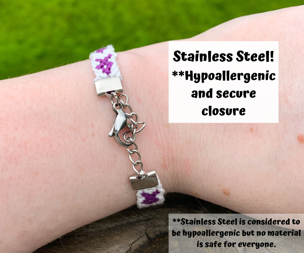 The back of a bracelet is shown. A lobster clasp connects on side to a short string of chain links. A box says Stainless Steel! **Hypoallergenic and secure closure. A note at the bottom says **stainless steel is considered to be hypoallergenci but no material is safe for everyone.