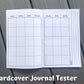 The calendar page of the hardcover journal is shown. There are 7 columns, 5 rows deep of squares with no dates. At the top of each column are the days of the week, but no color background. On the right page next to the box of squares you there are 3 vertical lines lining perpendicular to the way info would be written in the boxes. Notes is written on the left of the top line when facing to write.