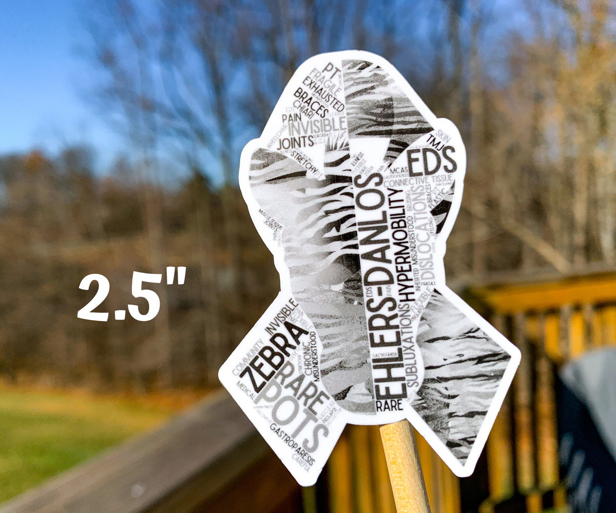 The 2.5 in word cloud ribbon is shown. You can see the words in matching black and grey colors. The words are things like Ehlers-Danlos, Hypermobility, Rare, Subluxations, Connective Tissue, Pain, Braces, Fragile, PT, and more.