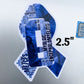 A 2 1/2 inch MECFS ribbon is shown on a silver laptop. It is next to a sticker that says Intel Core i7 to show size comparison to the small stickers on a computer.
