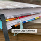 2 books are shown stacked. The bottom one has uneven ends and the top has flat ends.