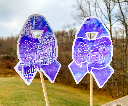 The word cloud and watercolor designs are shown on 2 sticks. Both ribbons feature a purple color awareness ribbon with intestines in the center. The word cloud design on the left is split in half with a word cloud on the left half of the ribbon and right half of the intestines.