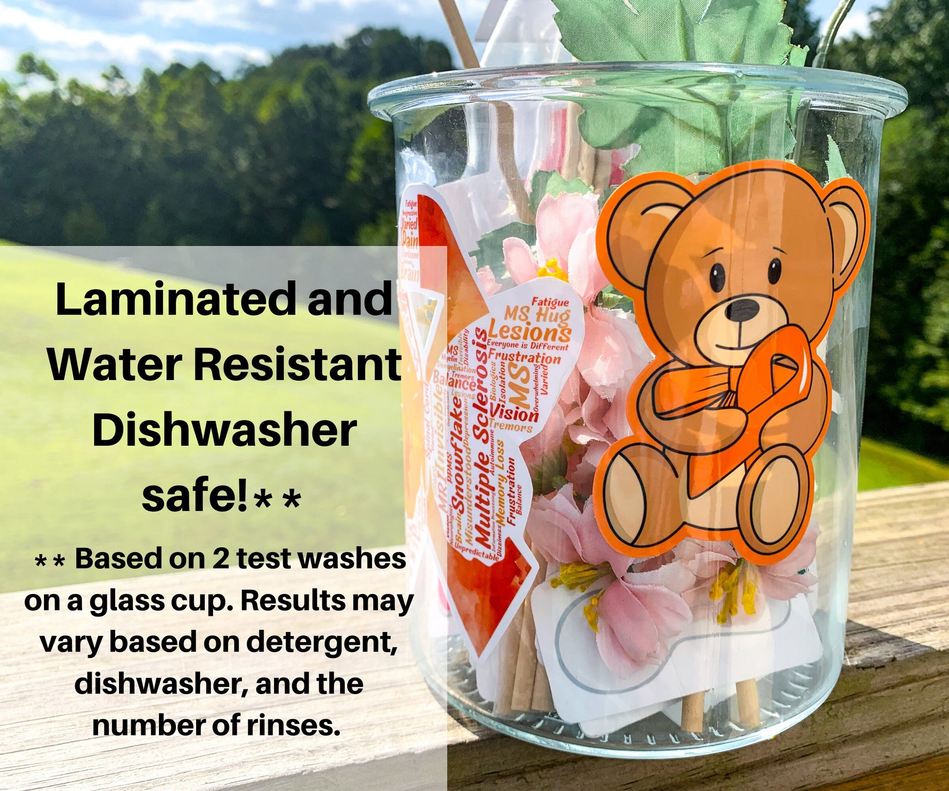 A bear with an orange ribbon and matching border is shown on a glass jar. This is for an example of surfaces it can stick to. A Multiple Sclerosis word cloud ribbon can be seen on the side of the jar. A note says Laminted and Water Resistant. Dishwasher safe **. ** Based on 2 test washes on a glass cup. Results may vary based on detergent, dishwasher, and the number of rinses.