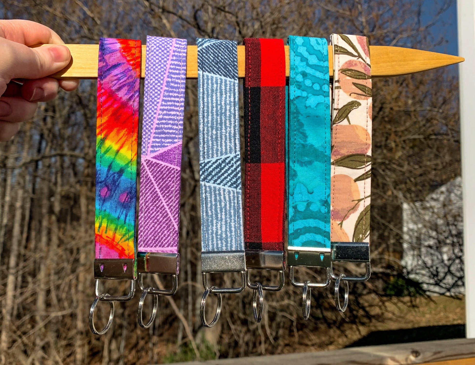 6 more wristlets are shown, in the colors Tie Dye, Pink Geo, Blue Geo, Red Plaid, Unlisted, Mauve Peach