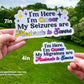The same 7 inch non binary sticker is shown again next to a 4 inch Bisexual flag colored I'm Here I'm Queer My Migraines are Moderate to Severe sticker, this one does not have sparkles. A note says sizes are approximate, may vary based on text requested.